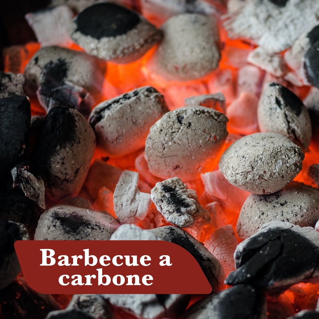 Carbone di legna acceso con braci rosse in un barbecue a carbone